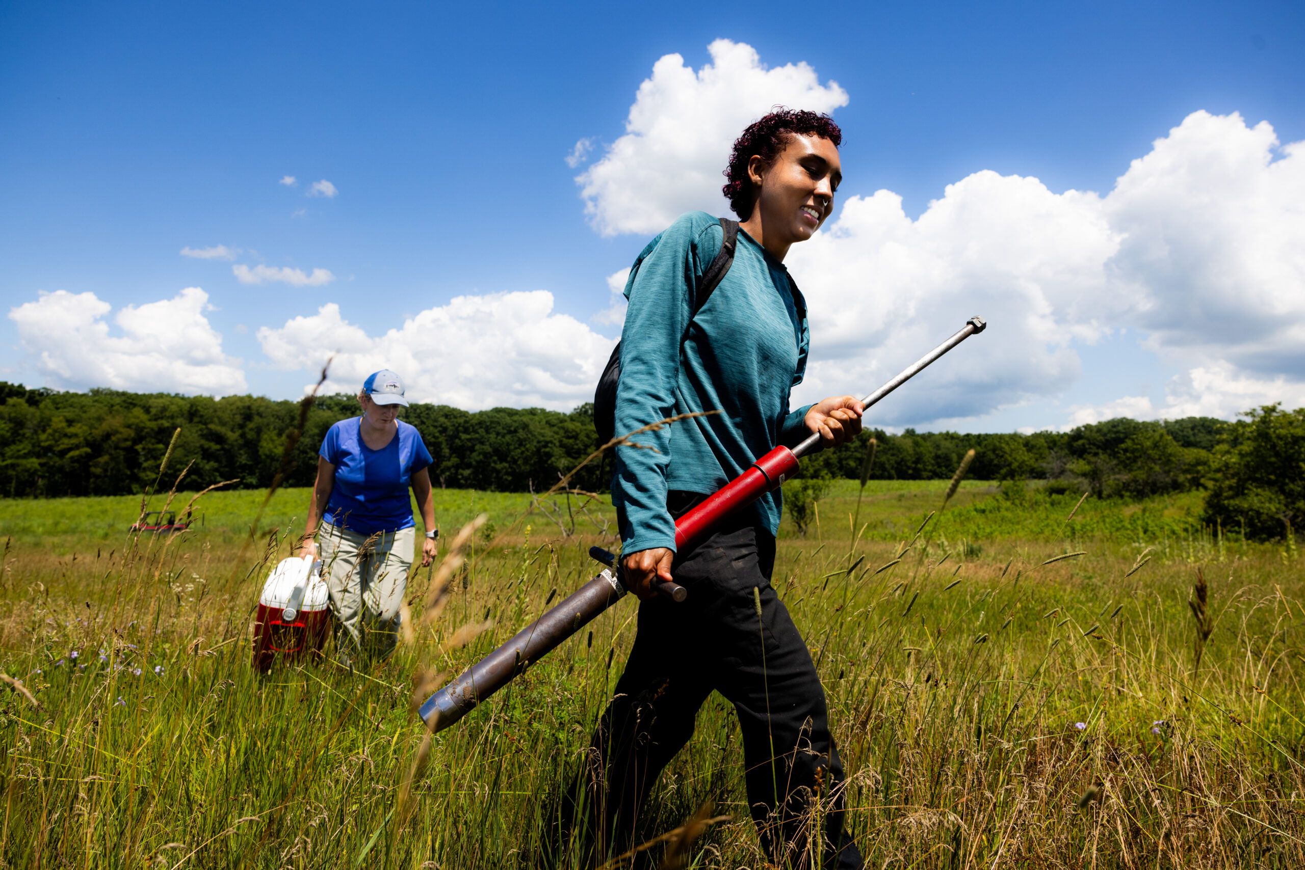 Kamal Ehrlich (right), a biological sciences graduate student at Northern Illinois University, collects soil samples at Nachusa Grasslands with Professor Holly Jones (left).